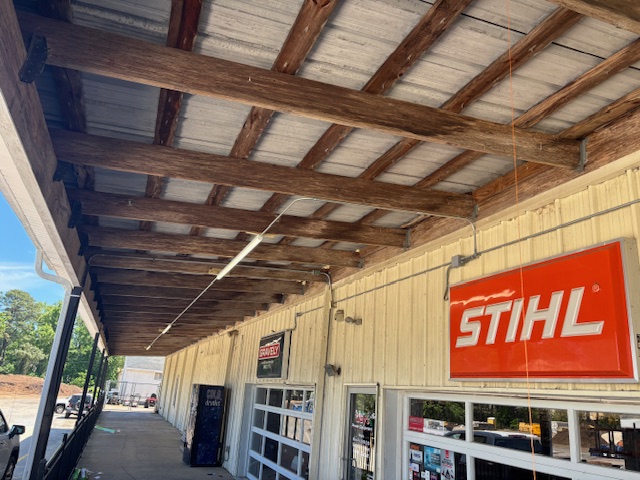 Commercial storefront canopy lighting installation viewed during daytime