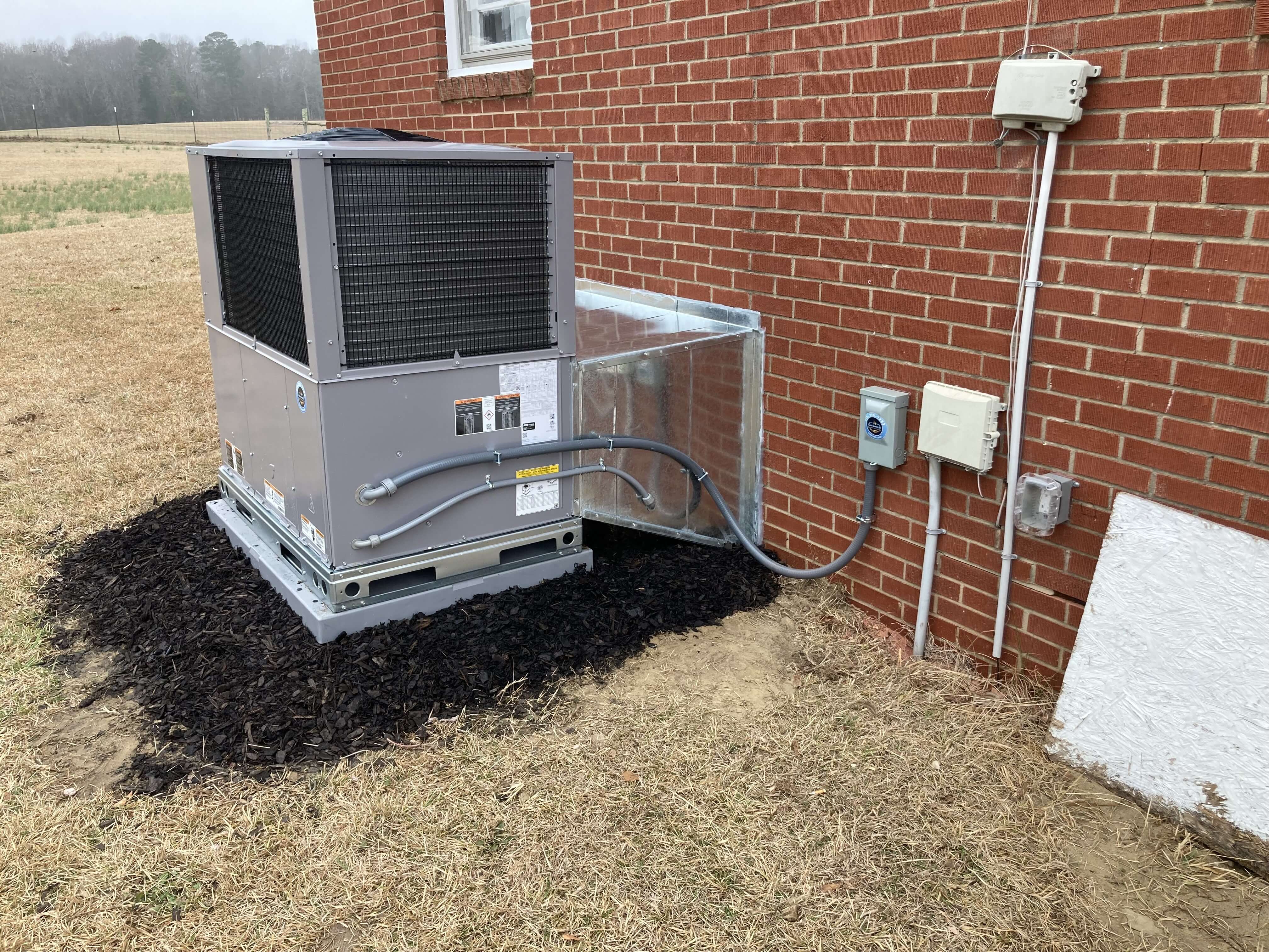 Residential HVAC package unit relocation with new electrical disconnect and conduit