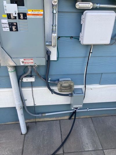 Generator interlock kit installed on a residential main panel with backfeed breaker