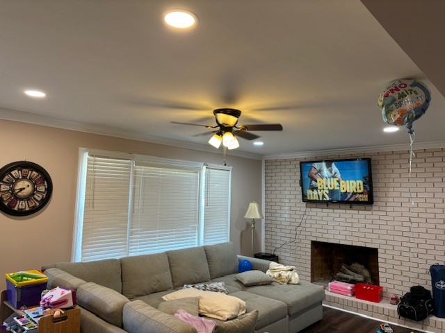 Residential living room with recessed LED can lighting and a ceiling fan installation