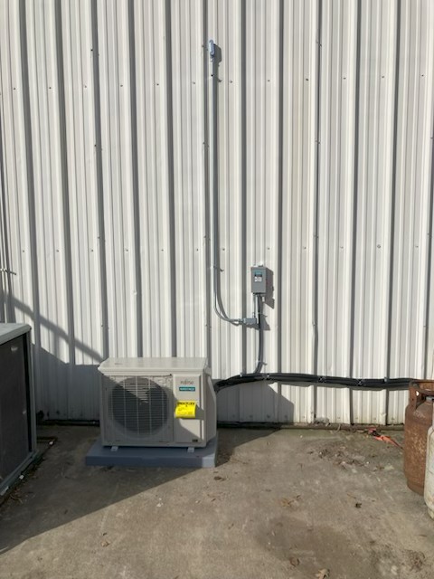 Commercial workshop mini-split heat pump installation with exterior disconnect